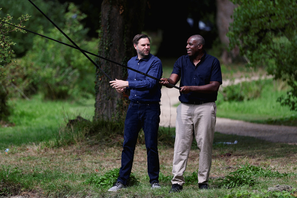 Britain's Foreign Secretary David Lammy, right, and US Vice President JD Vance fish in a lake in the grounds of Chevening House in Kent, England
