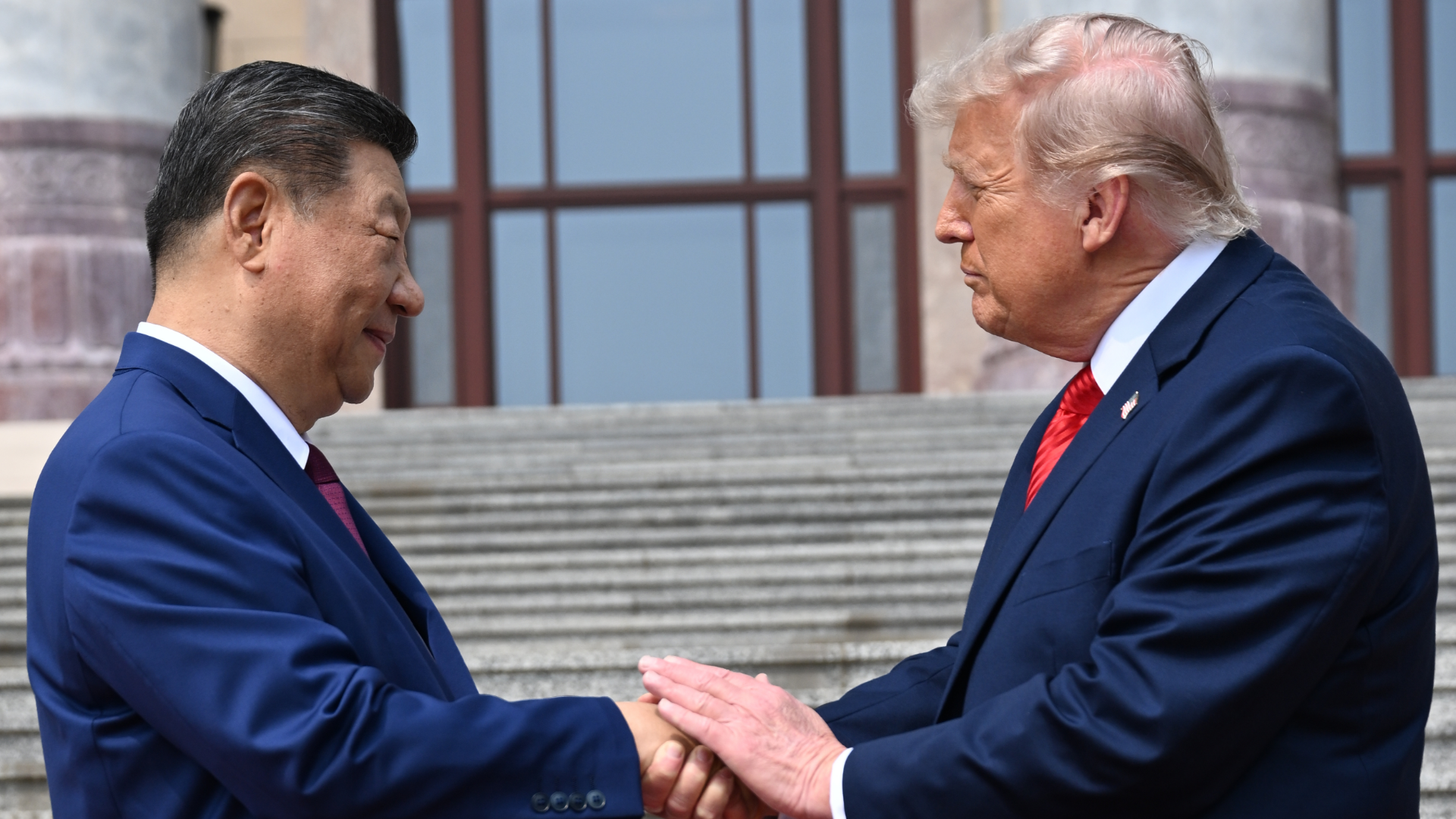 Chinese President Xi Jinping, left, shakes hands with US President Donald Trump at the Great Hall of the People in Beijing.