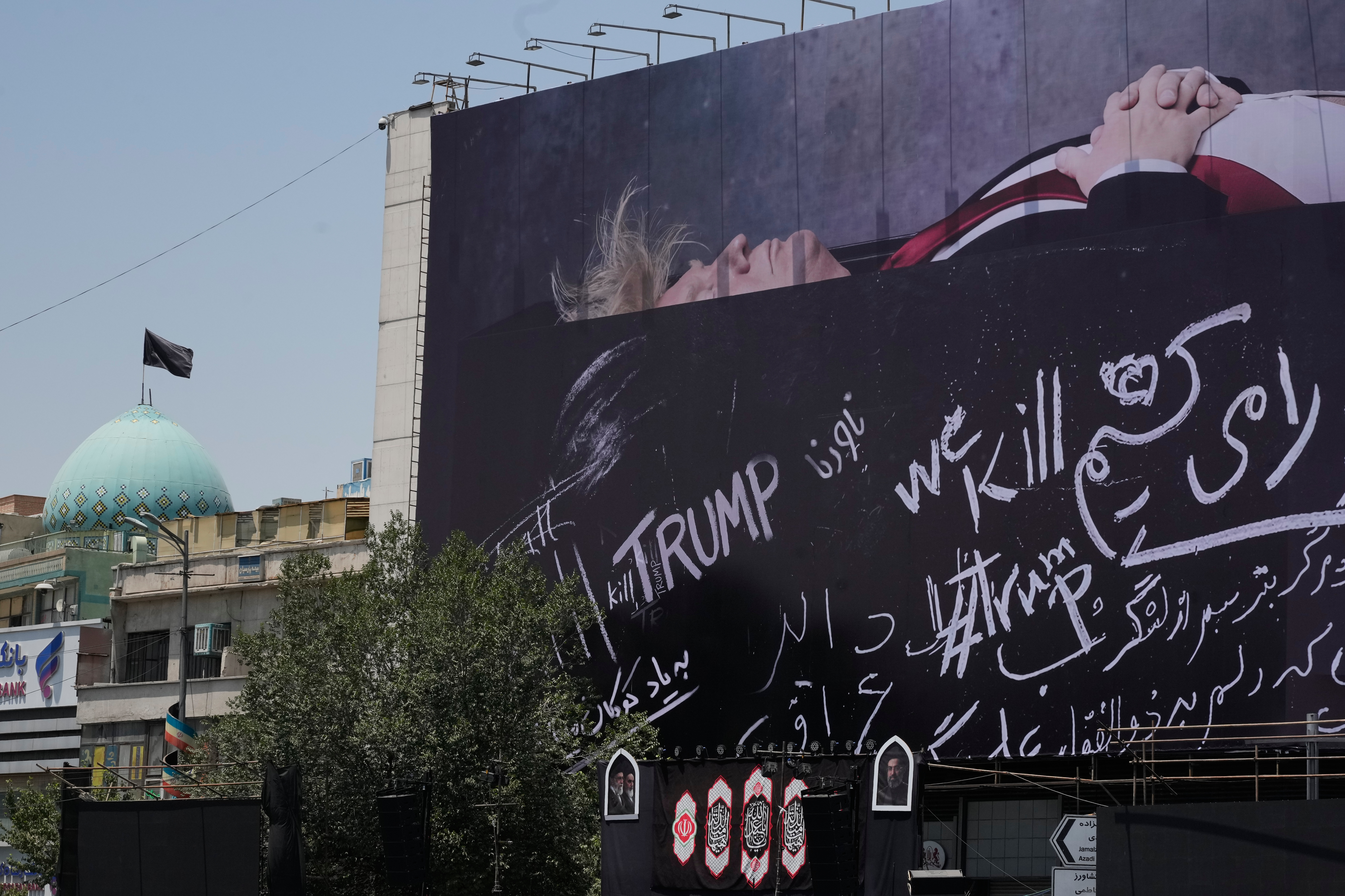 A billboard depicting US President Donald Trump lying on what appears to be a coffin .
