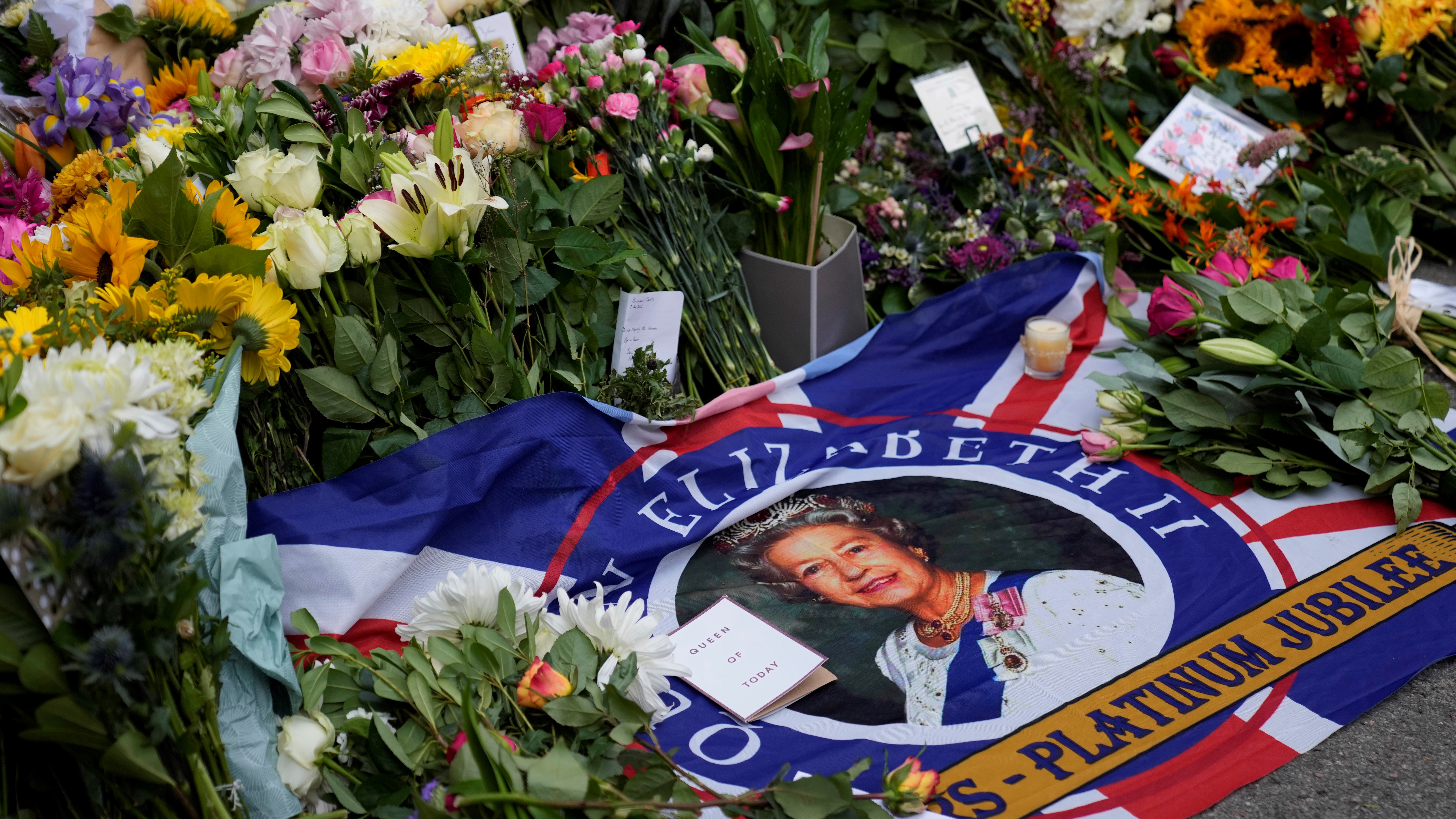 Notes and floral tributes for Queen Elizabeth II outside the gates of Balmoral Castle in Aberdeenshire, Scotland.