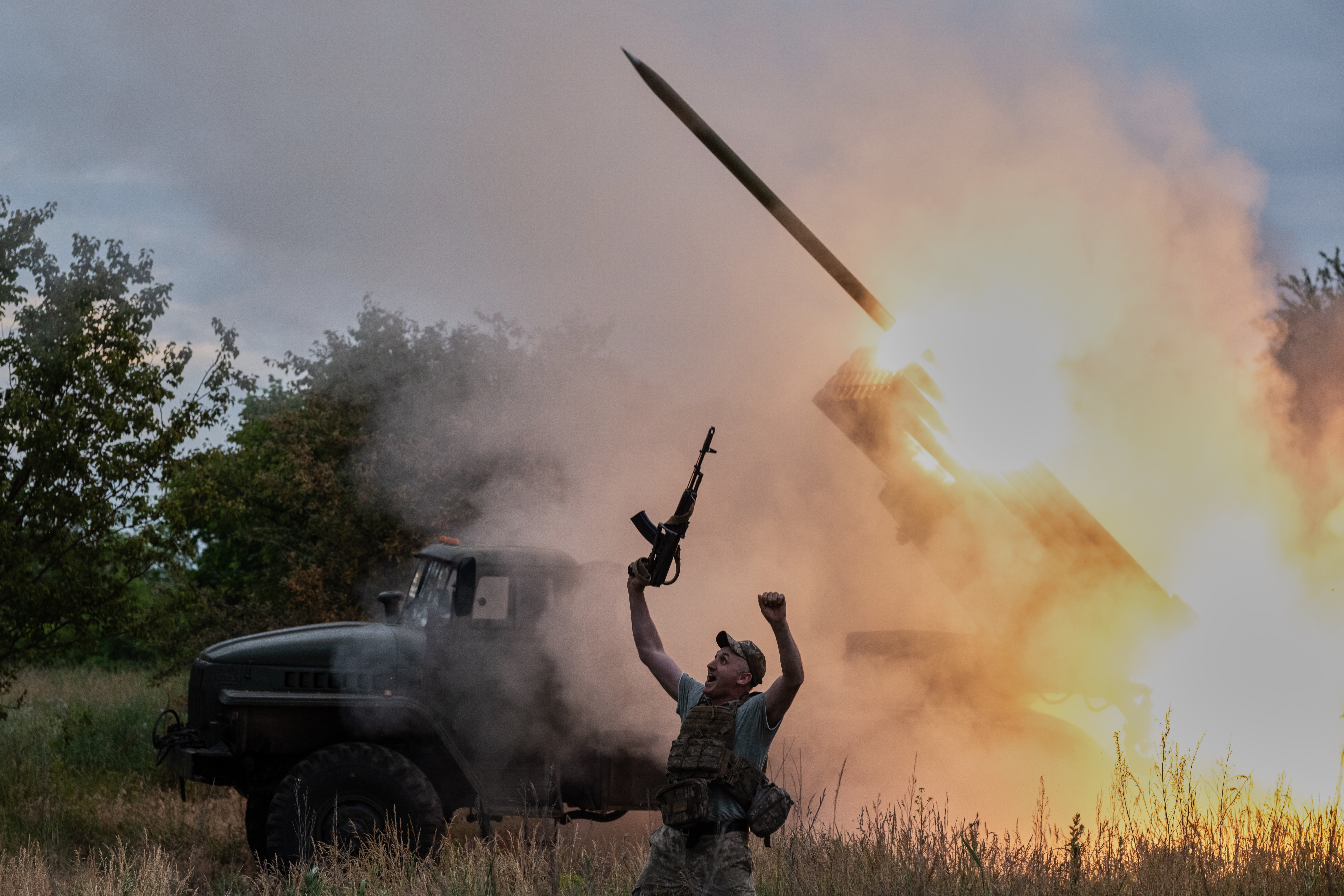 In this photo provided by Ukraine's 93rd Kholodnyi Yar Separate Mechanized Brigade press service, a soldier reacts as an MRLS BM-21 