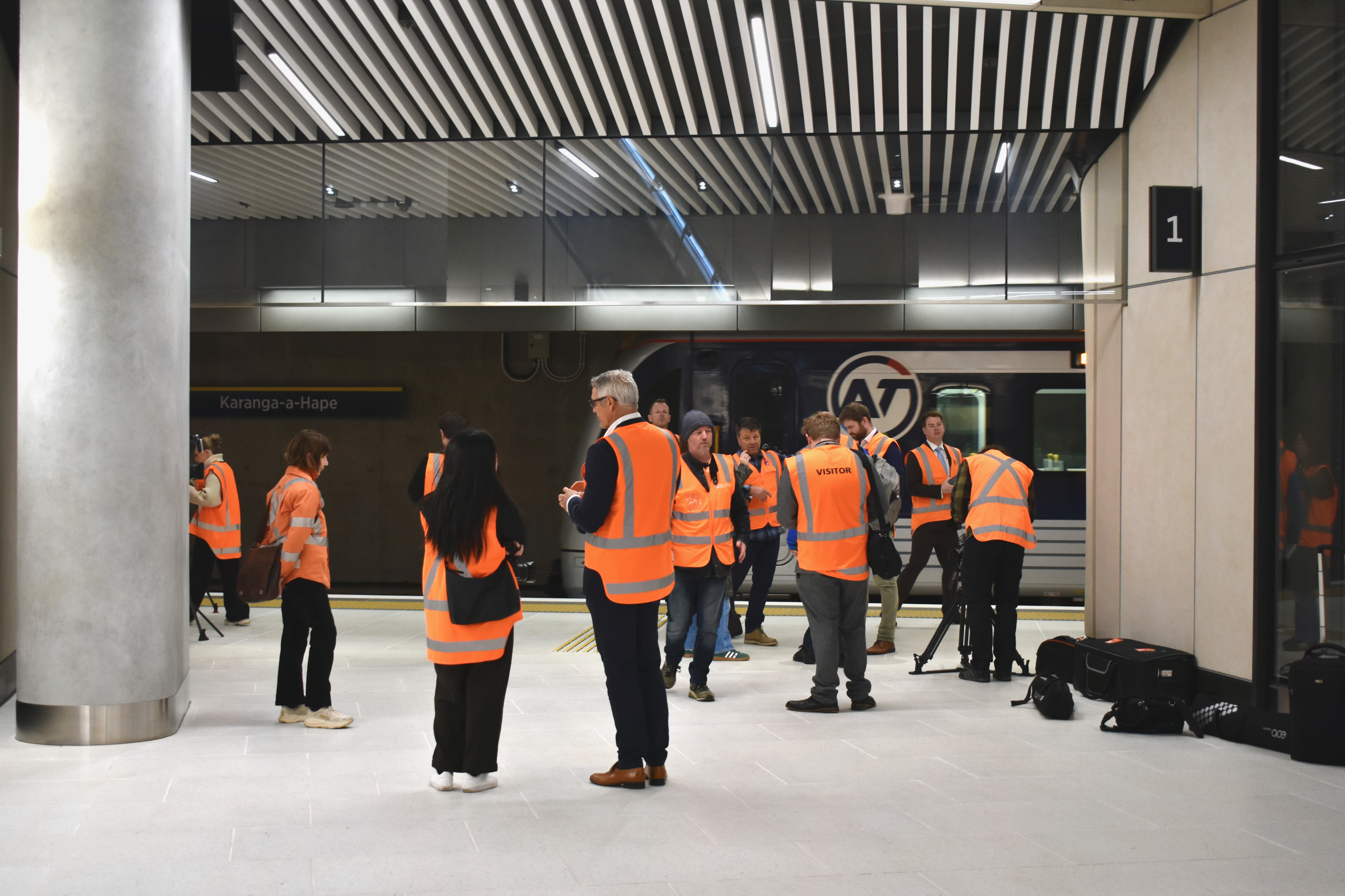 Journalists gather for a media conference at Karanga-a-Hape station. 