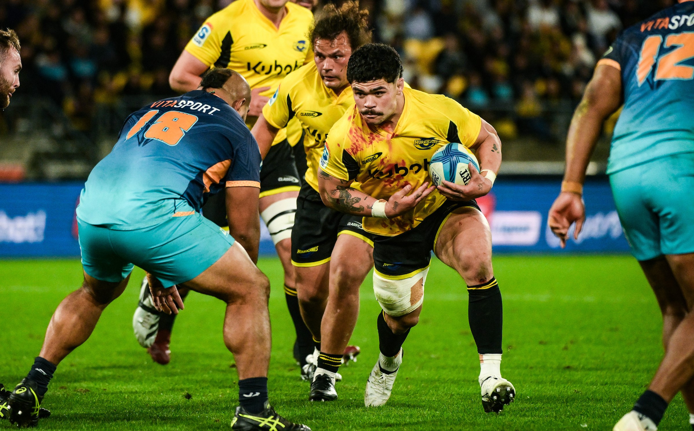 A blood-soaked Du'Plessis Kirifi carries the ball against Moana Pasifika last month.