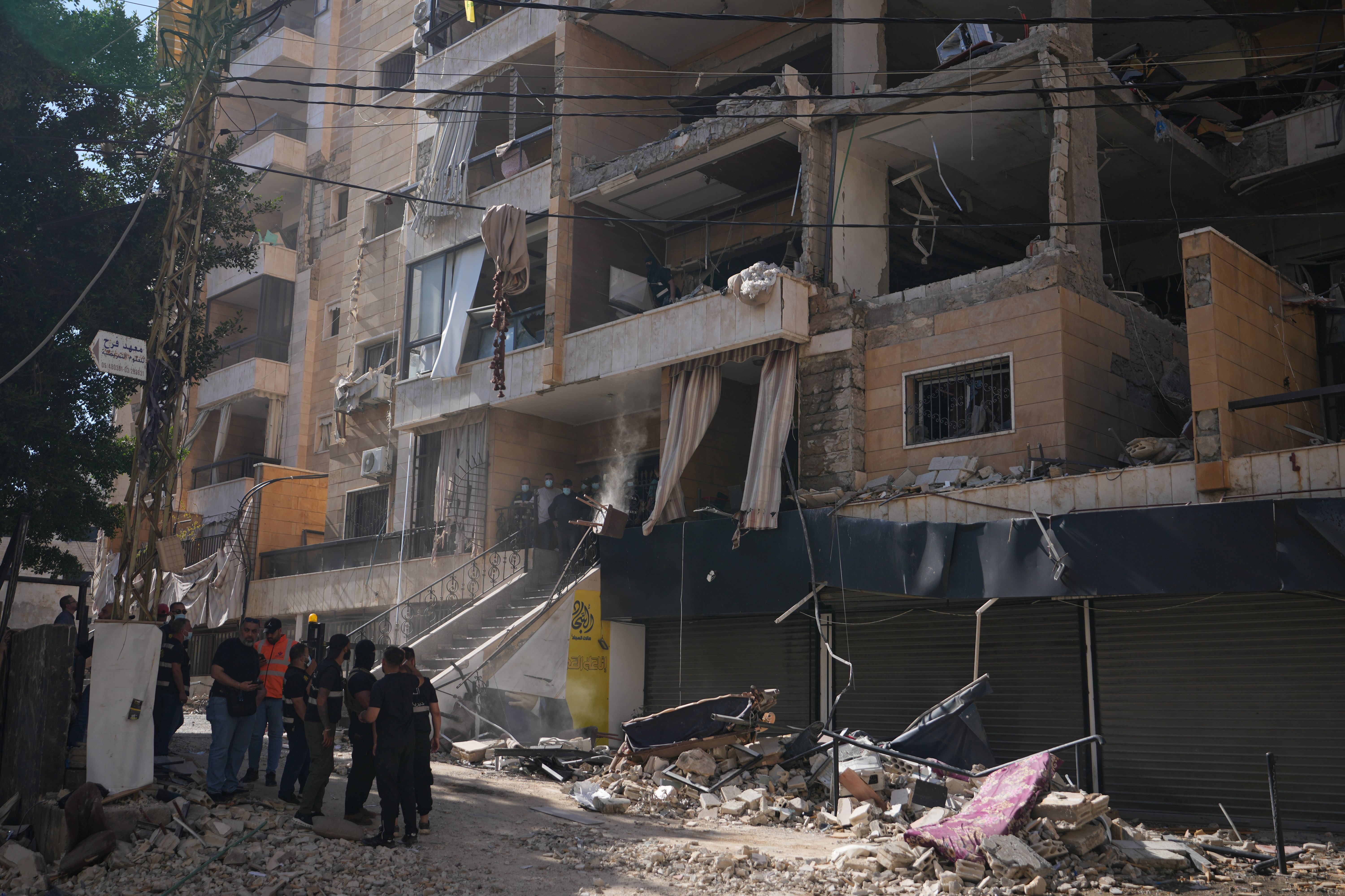Lebanese security officers gather at the site where an Israeli airstrike hit a building in Dahiyeh, Beirut's southern suburb, Lebanon.