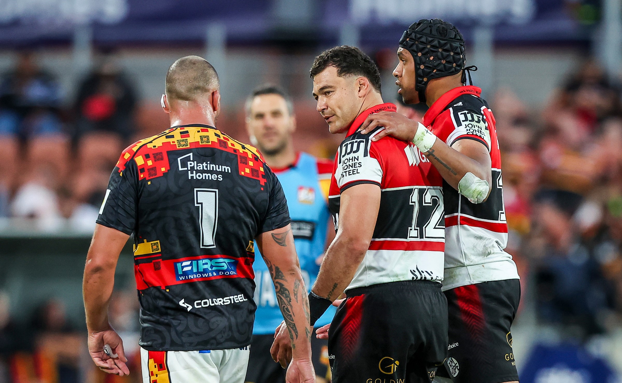Crusaders skipper David Havili has words with Chiefs prop Jared Proffitt.