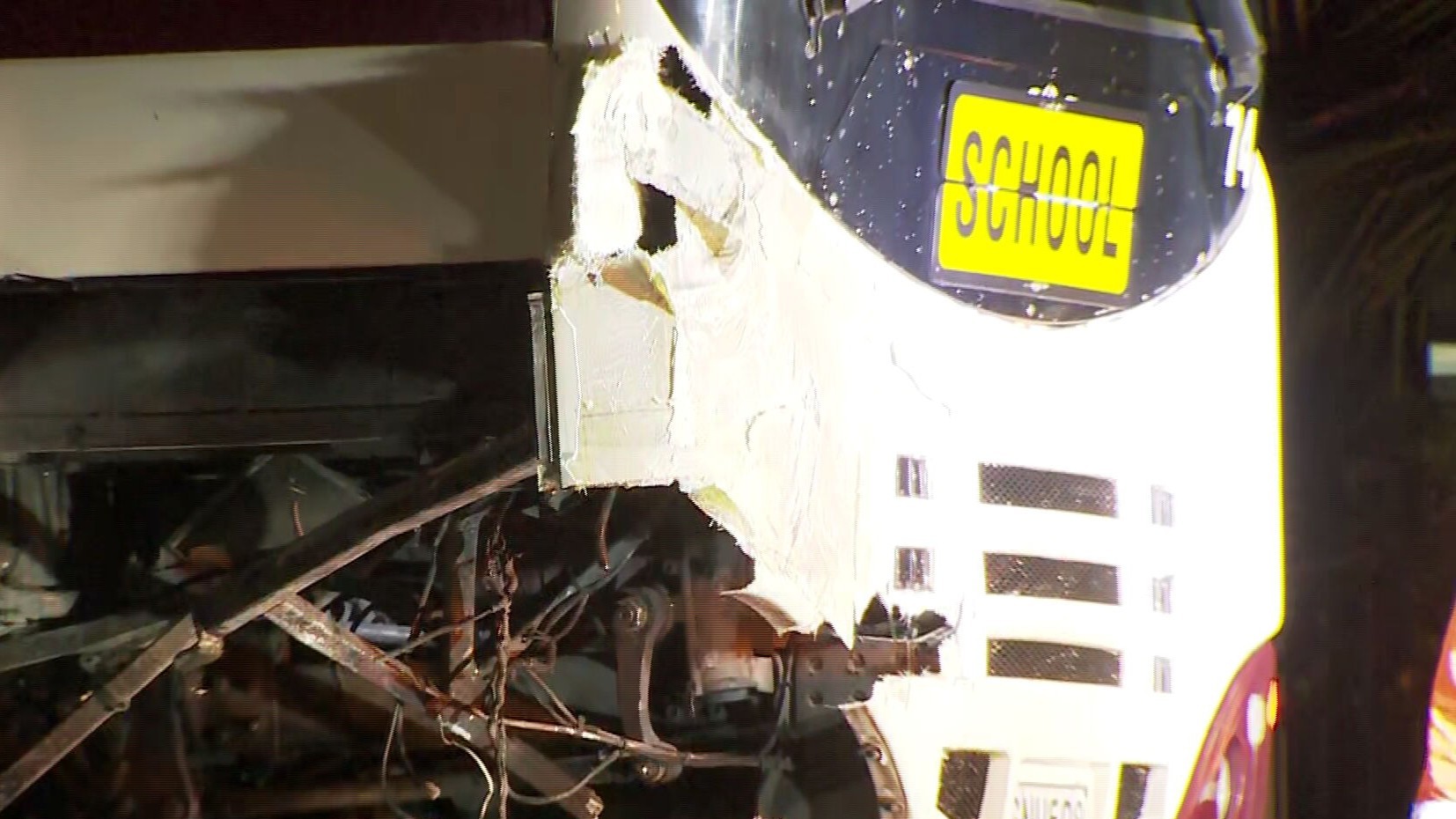 Crashed bus with school sign.