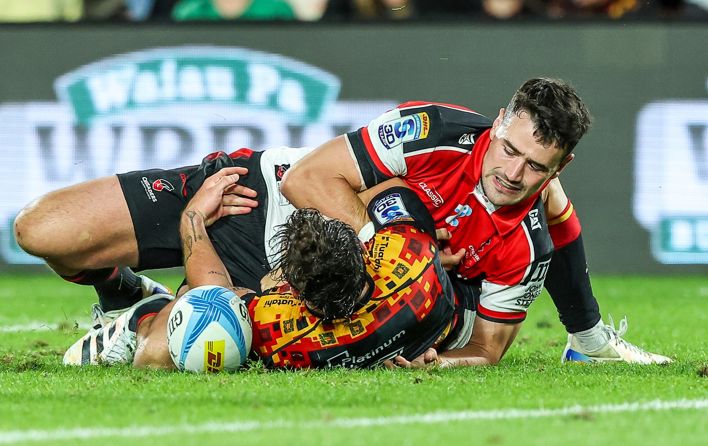 Crusaders fullback Will Jordan tackles Chiefs wing Leroy Carter in the dying seconds at Waikato Stadium.