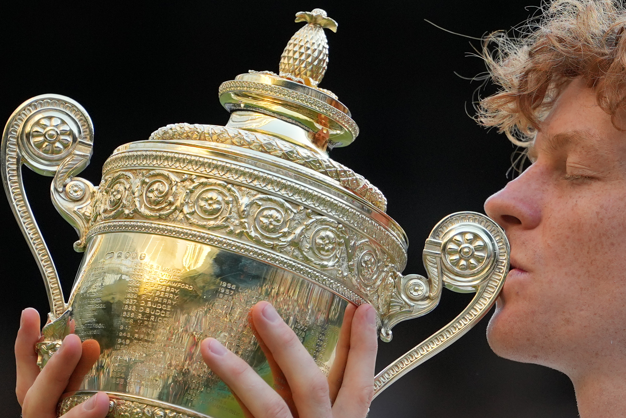 Jannik Sinner of Italy kisses the winners trophy after defeating Alexander Zverev of Germany in the men's singles final at Wimbledon Tennis Championships in London.