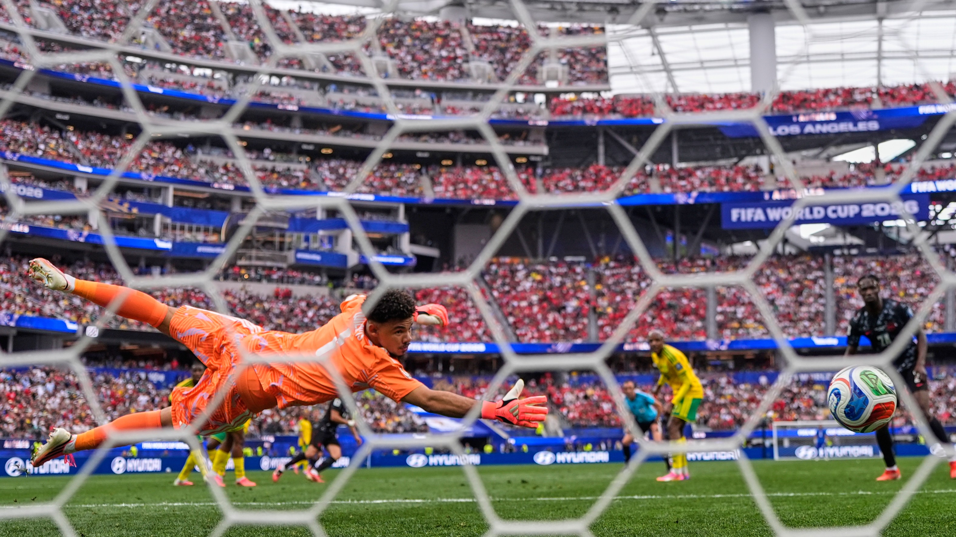 Canada's Stephen Eustaquio (7) scores their opening goal past South Africa goalkeeper Ronwen Williams (1) during the World Cup round of 32 soccer match between South Africa and Canada in Inglewood, Calif., near Los Angeles, Sunday, June 28, 2026.