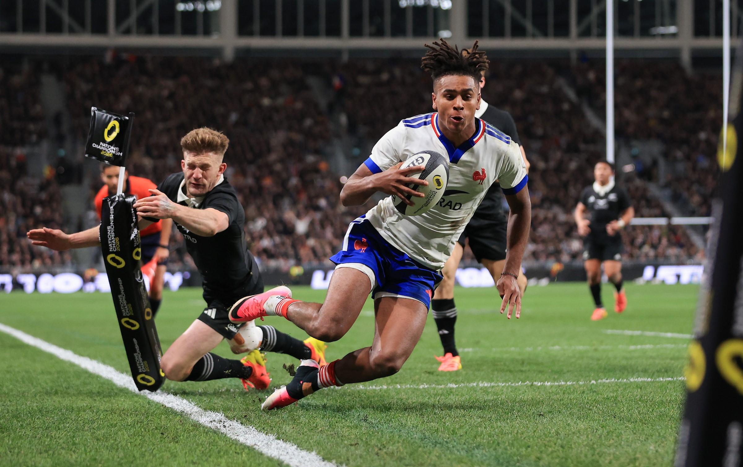 France wing Theo Attissogbe evades Damian McKenzie to score in the corner against the All Blacks in Christchurch.