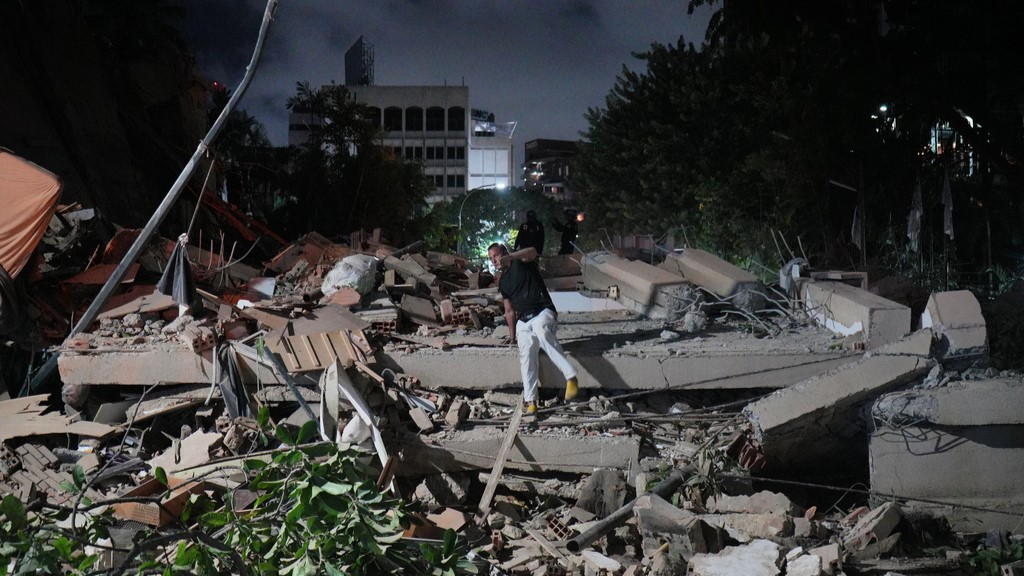 A man jumps on a collapsed building after an earthquake in Caracas, Venezuela.