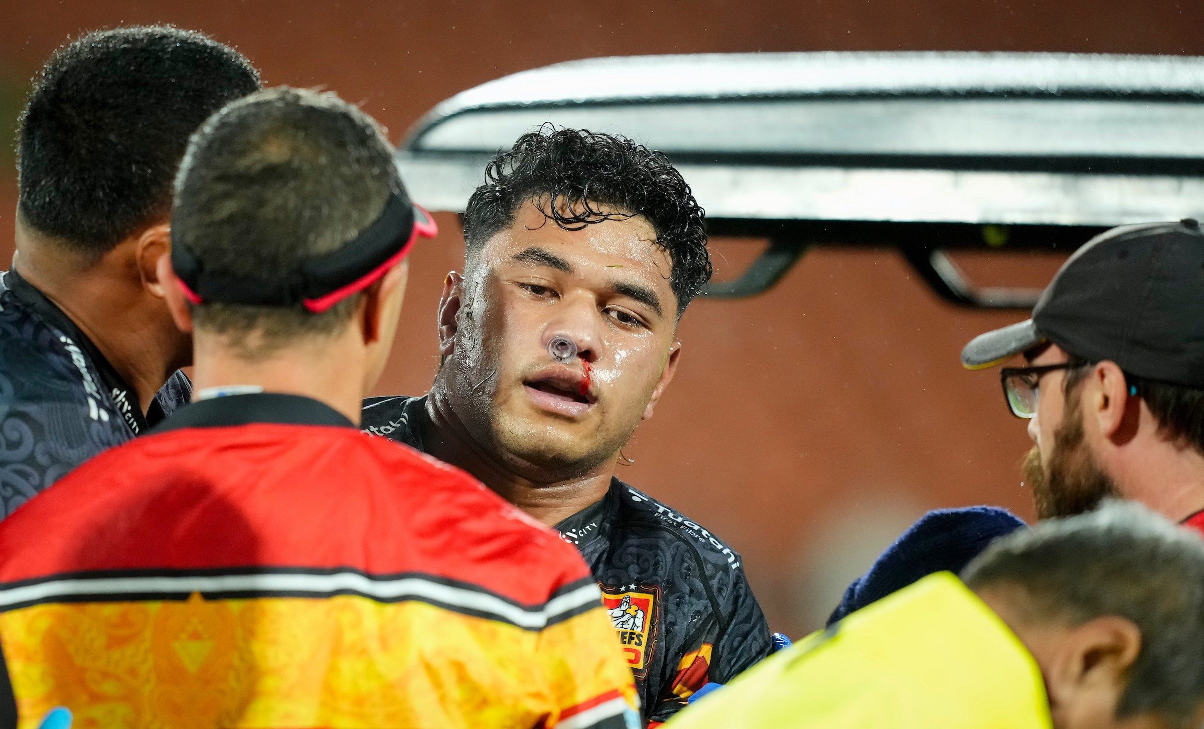 Wallace Sititi is taken from the field after being concussed against the Reds.