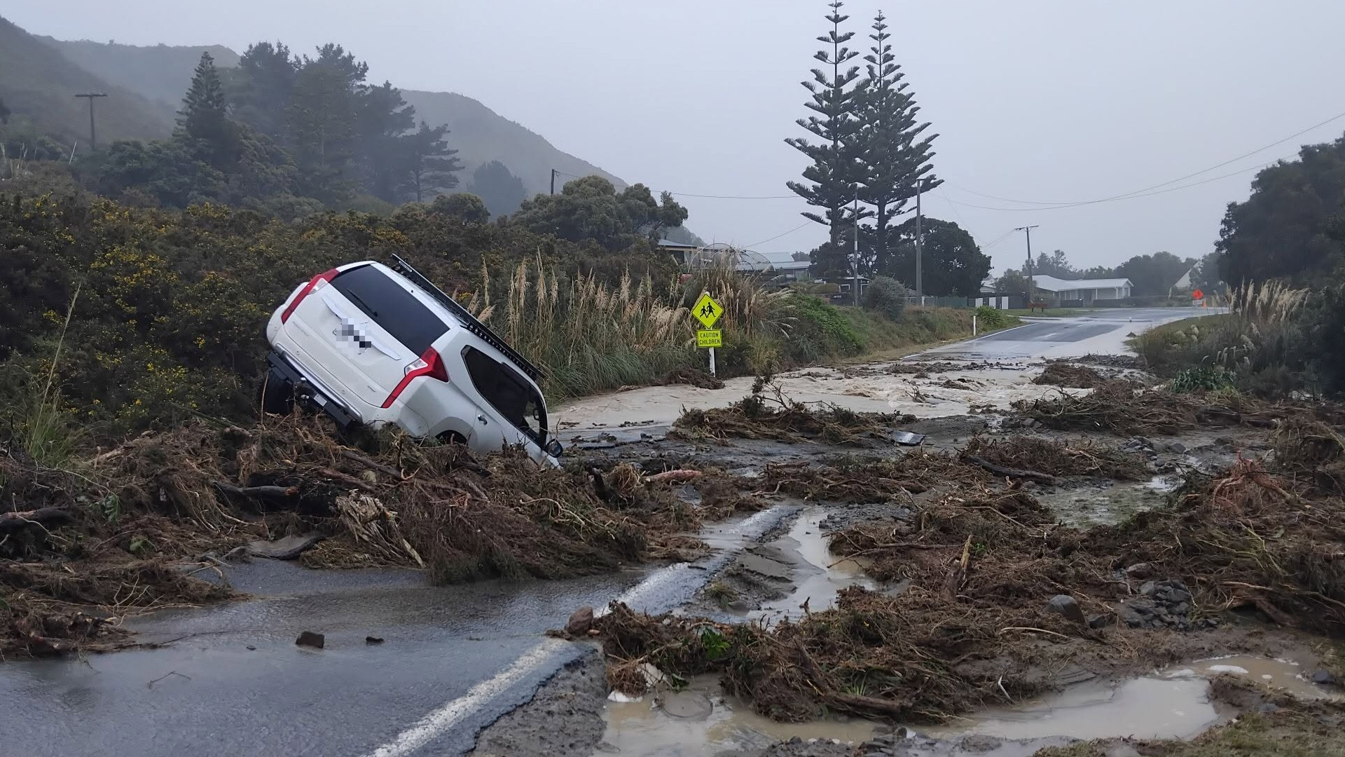 A car stranded by floodwaters and mud in Cape Palliser, Wairarapa.