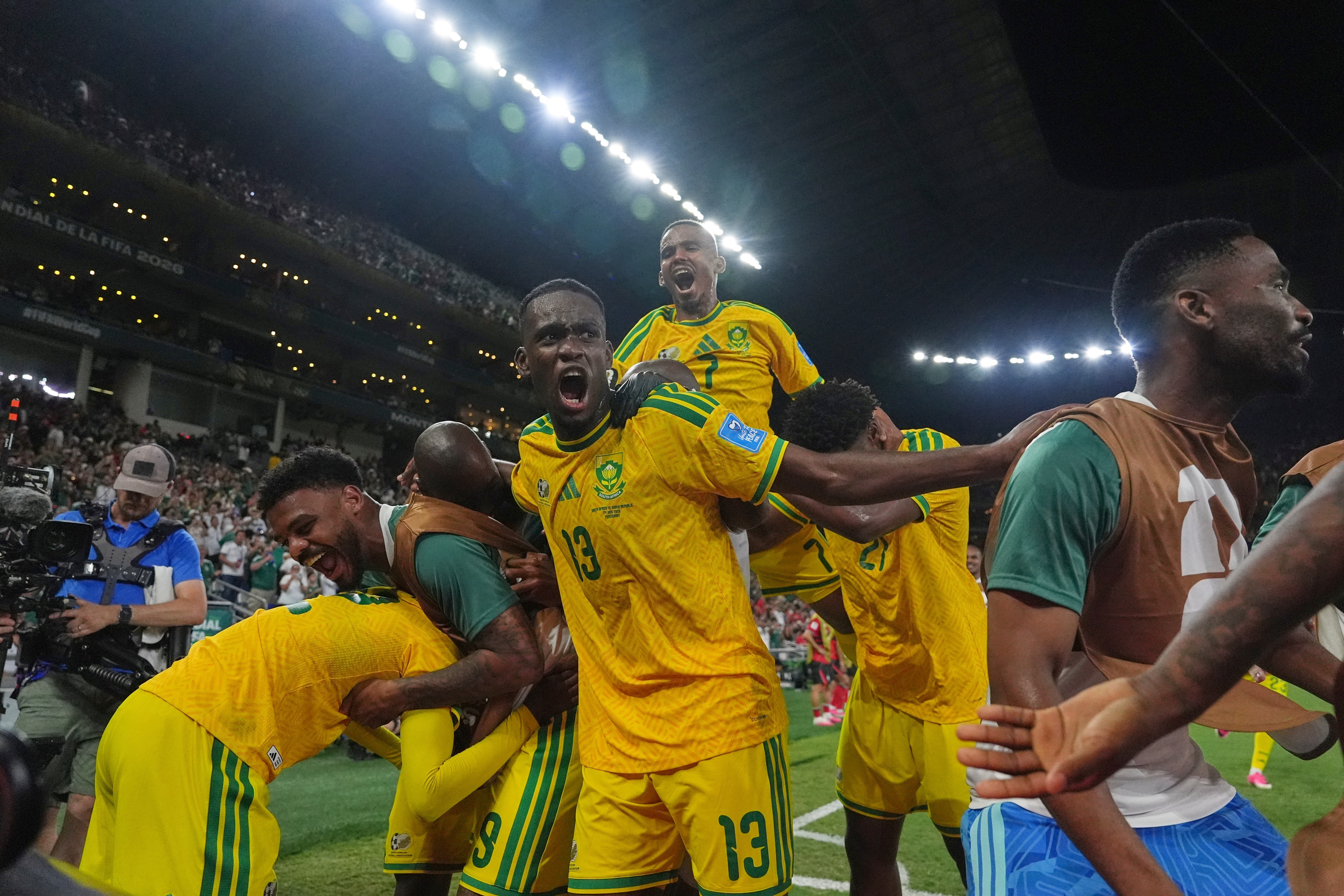 South Africa's Thapelo Maseko (12) celebrates with teammates after scoring his side's first goal during the World Cup Group A match between South Africa and South Korea in Guadalupe. 