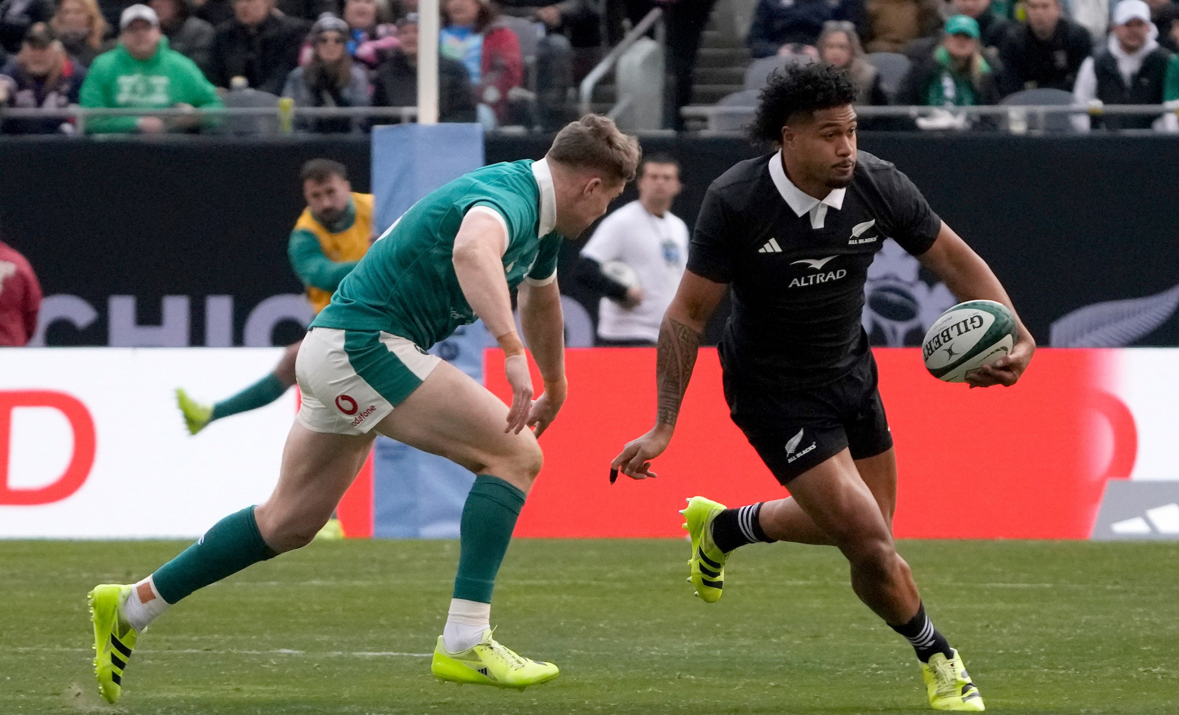 Leicester Fainga'anuku gets past Ireland's Garry Ringrose in Chicago.