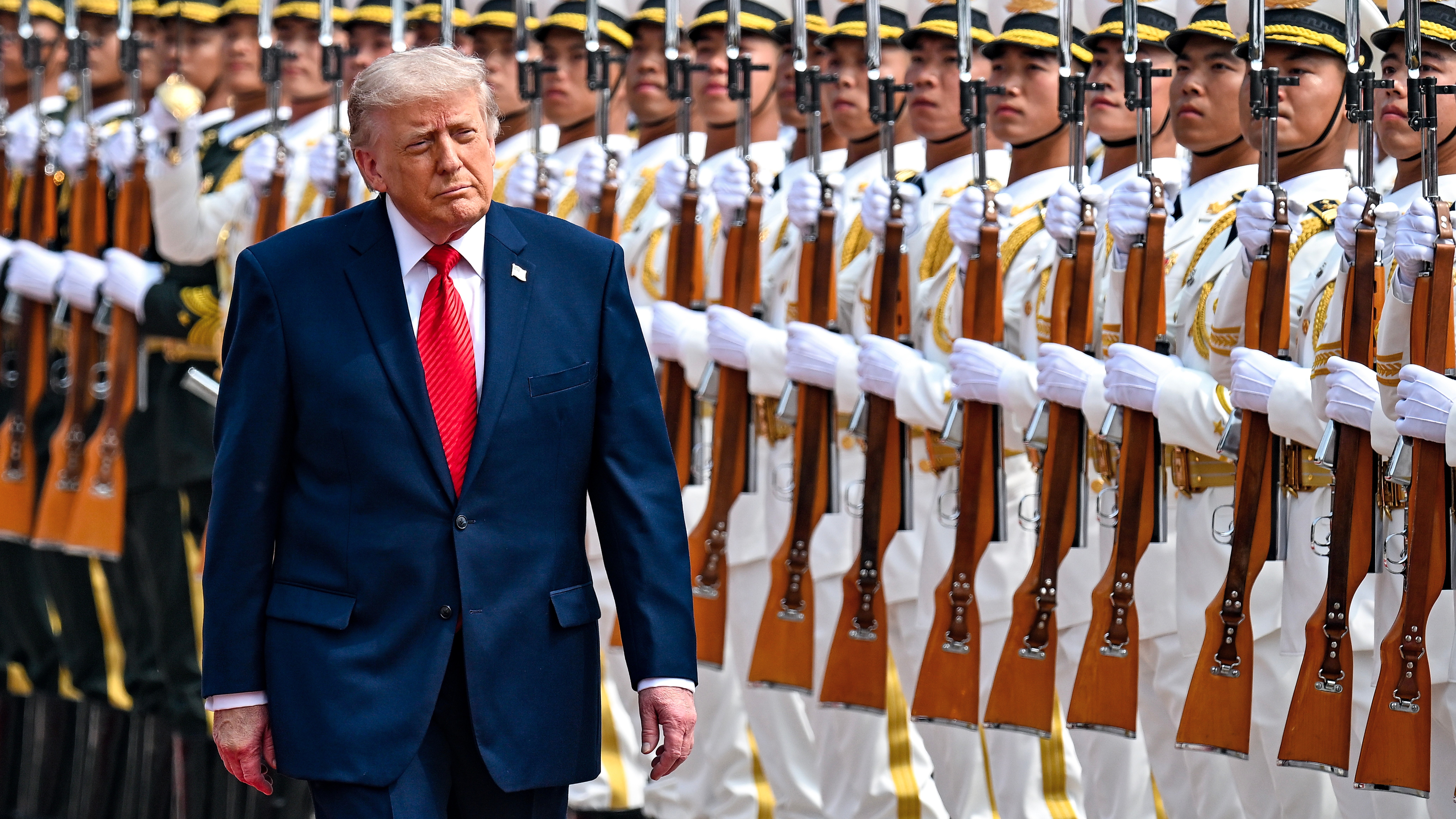 President Donald Trump reviews troops at the Great Hall of the People in Beijing.