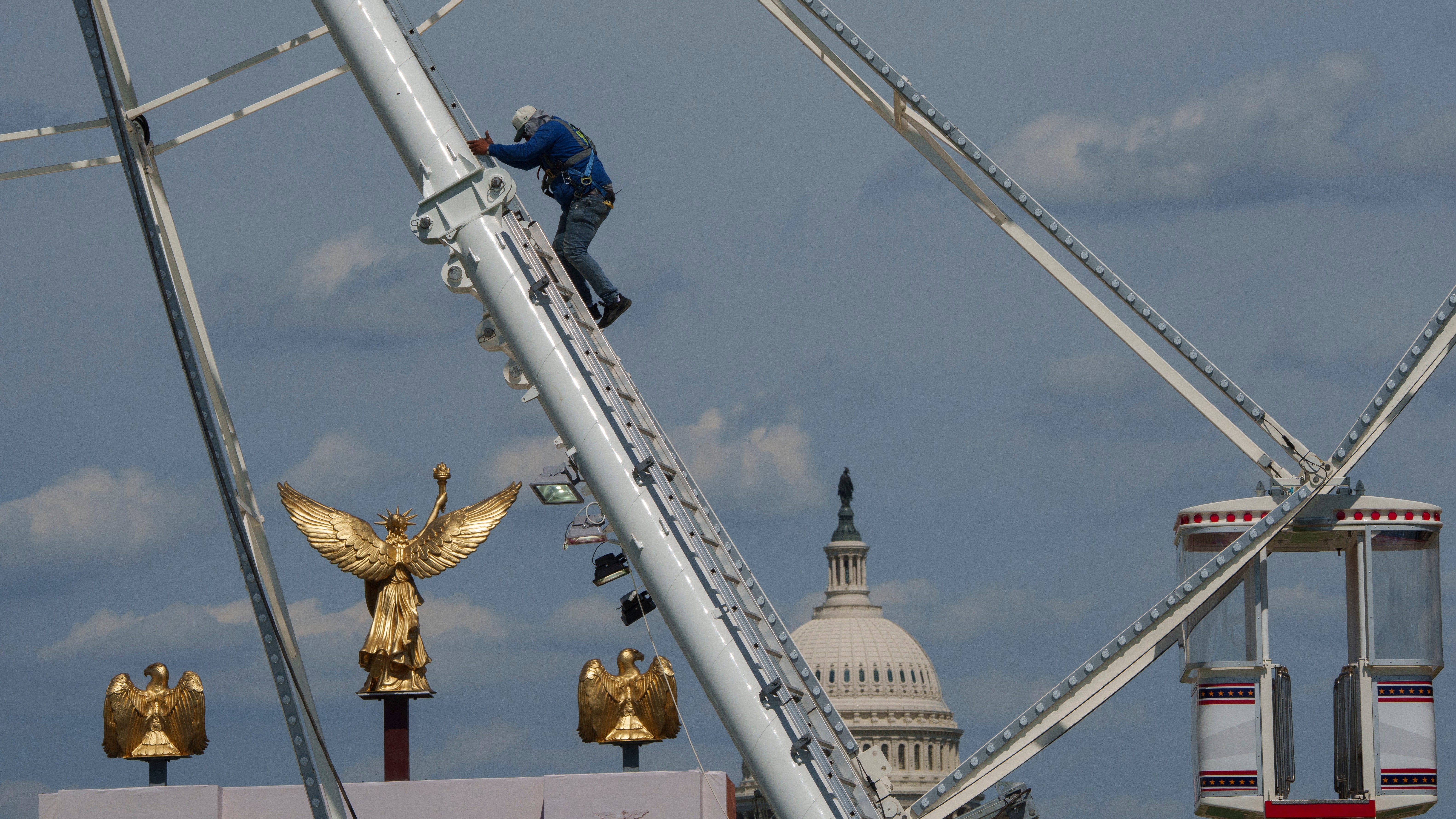 The US Capitol is seen in the background of the ferris wheel as preparation continues for the Great American State Fair on the National Mall, Sunday, June 21, 2026, in Washington.