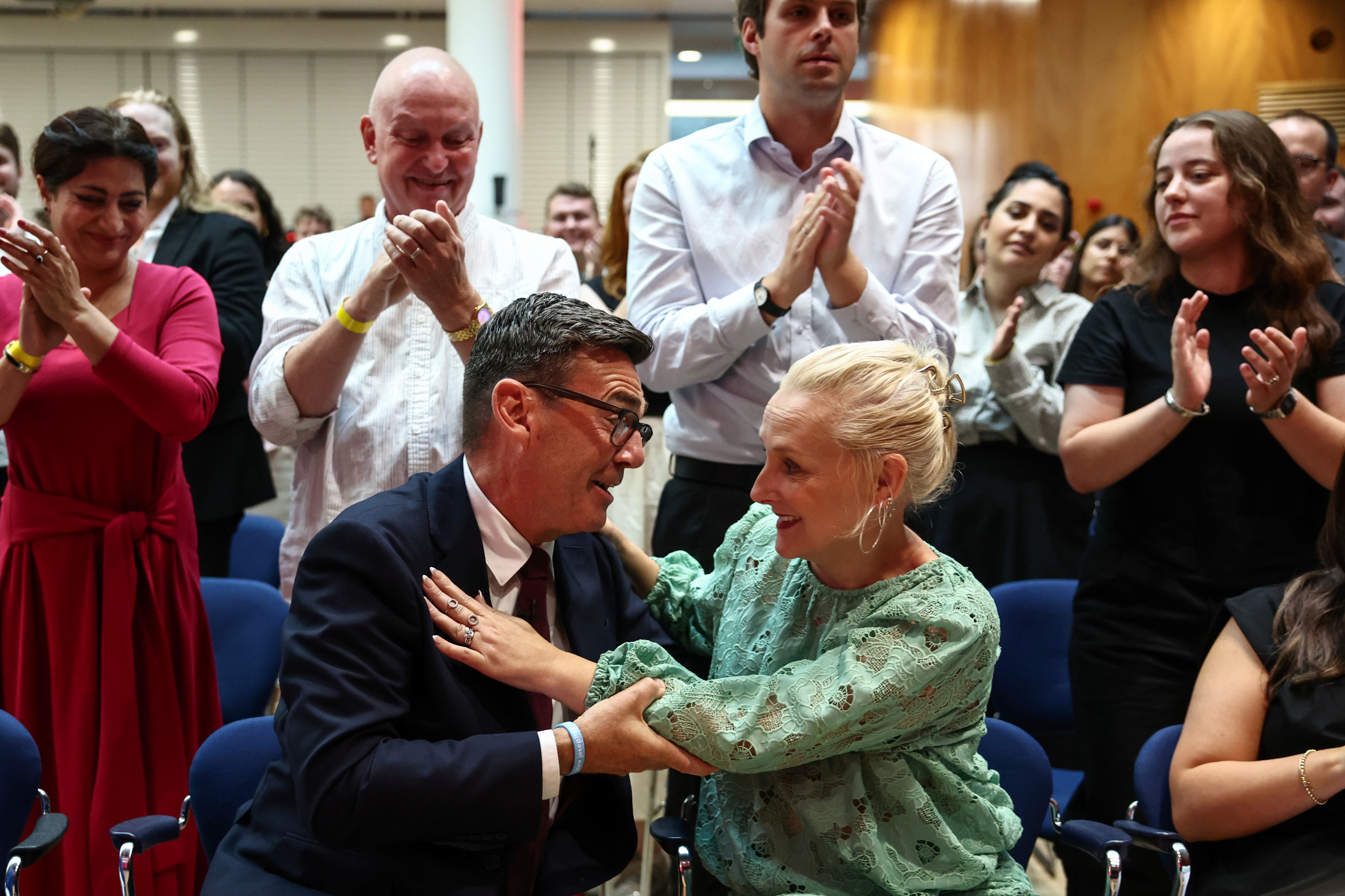 Andy Burnham hugs his wife Marie-France van Heel as he is confirmed as the Labour Party's new leader and the country's next prime minister, during 'Labour's Special Conference' in central London, Friday July 17, 2026. 