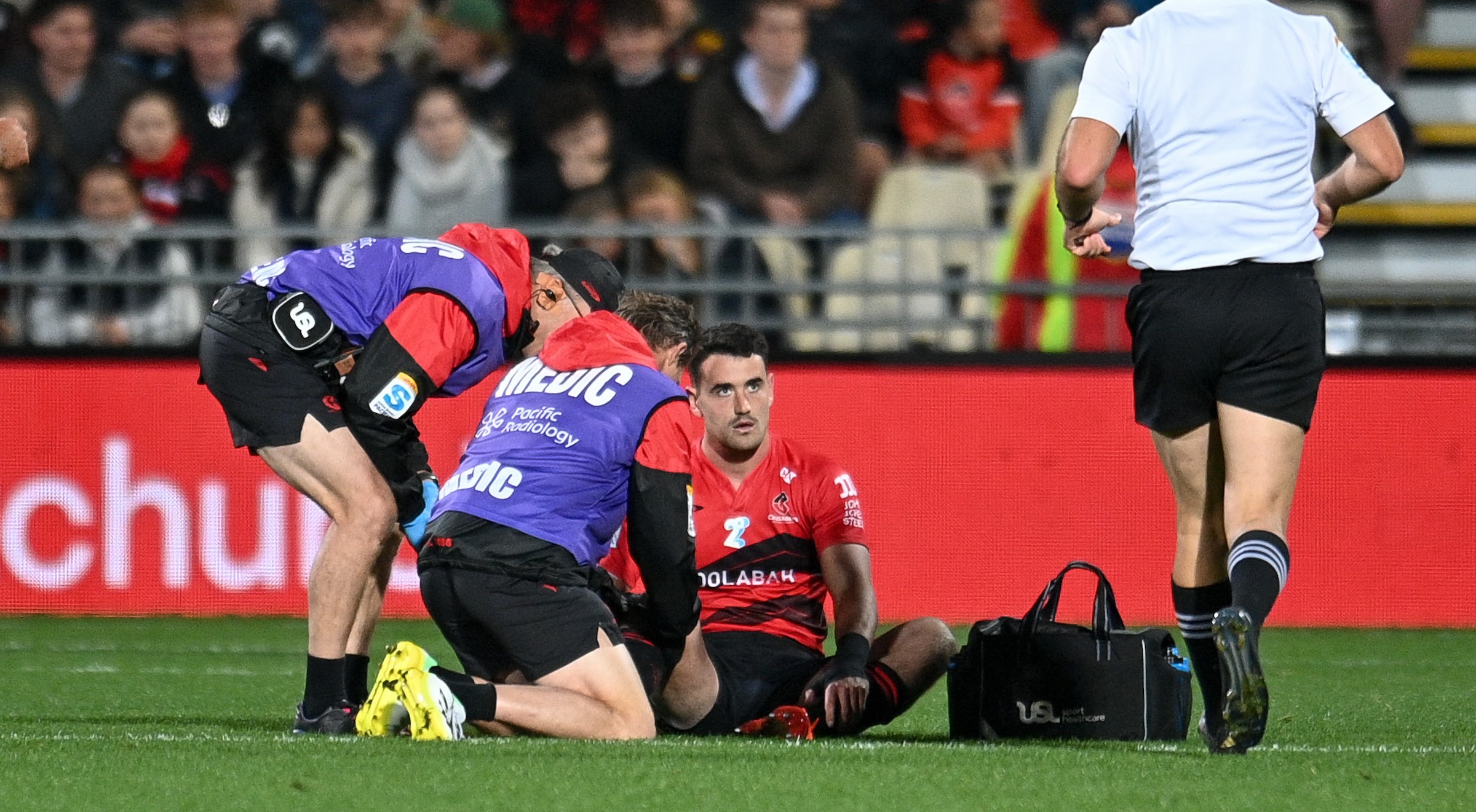 Will Jordan receives treatment on a knee injury suffered in the Crusaders' loss to the Chiefs.