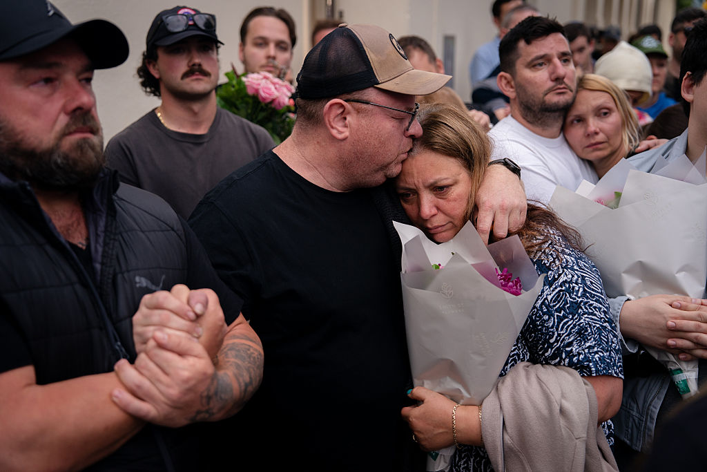  The parents of shooting victim, 10-year-old Matilda, seen during a candlelight vigil at Bondi Pavilion at Bondi Beach.