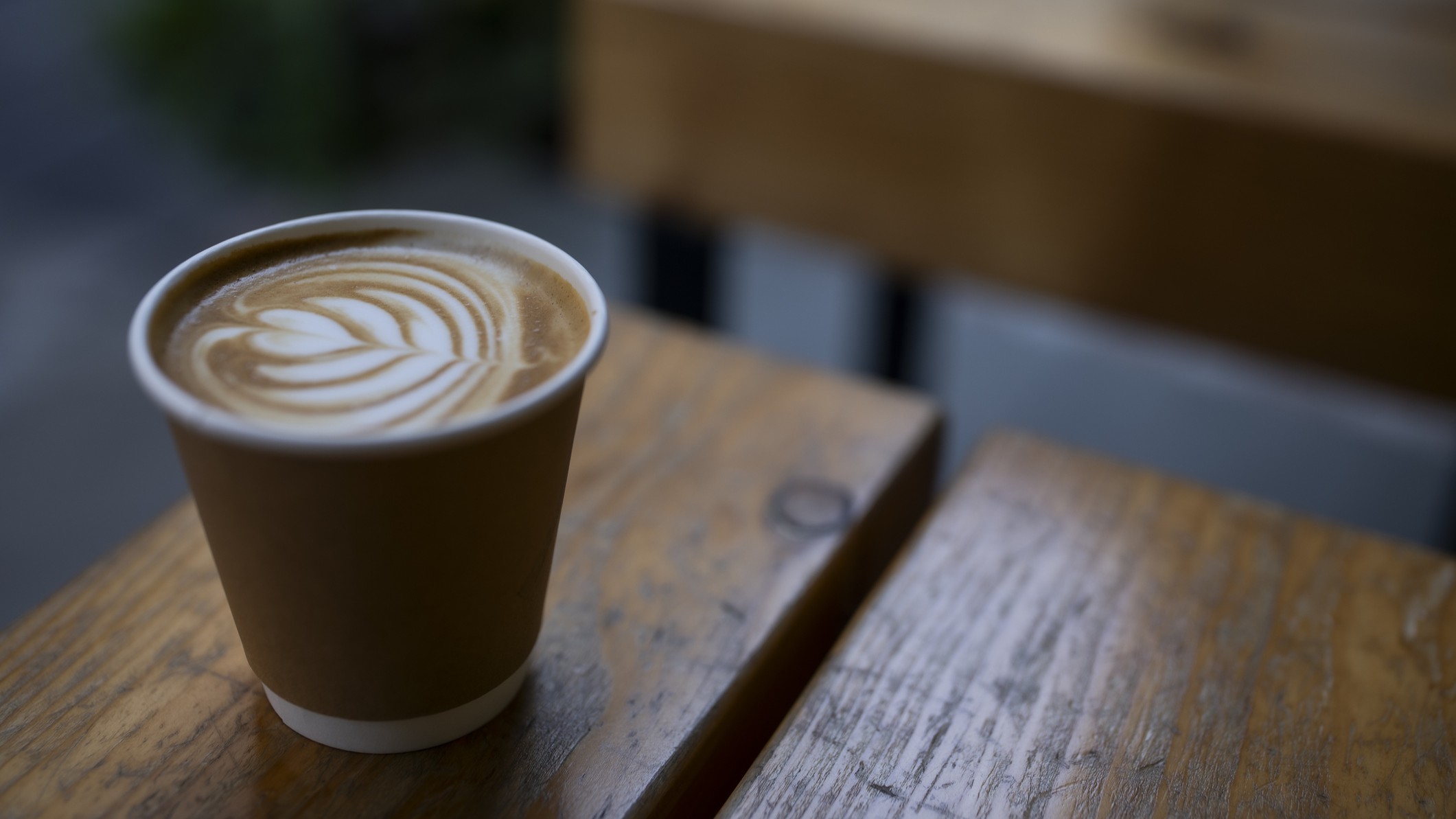 A latte coffee in a takeaway cup.