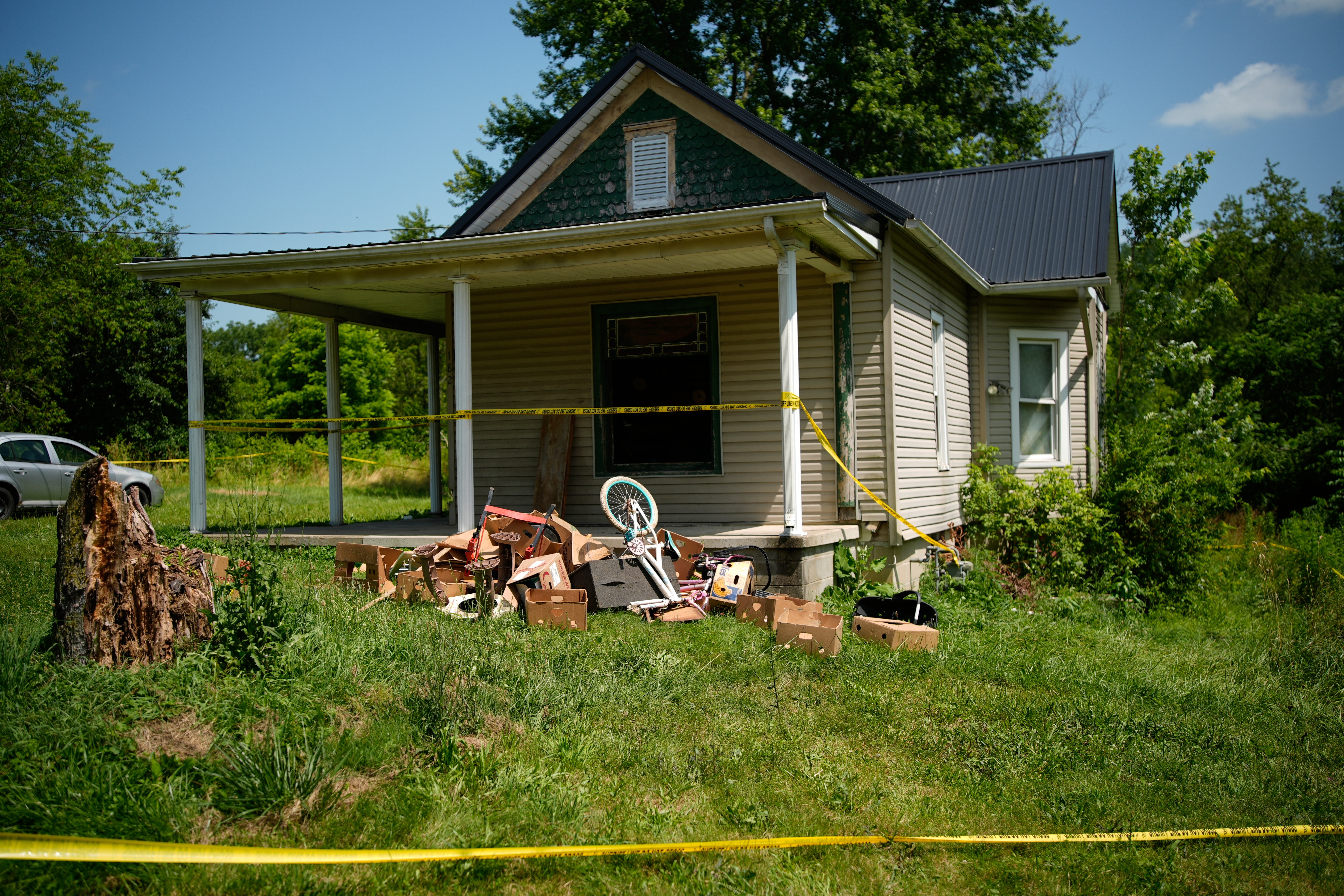 Police tape surrounds a home where authorities say they removed 16 children and arrested four adults in Hamden, Ohio, Wednesday, July 1, 2026. 