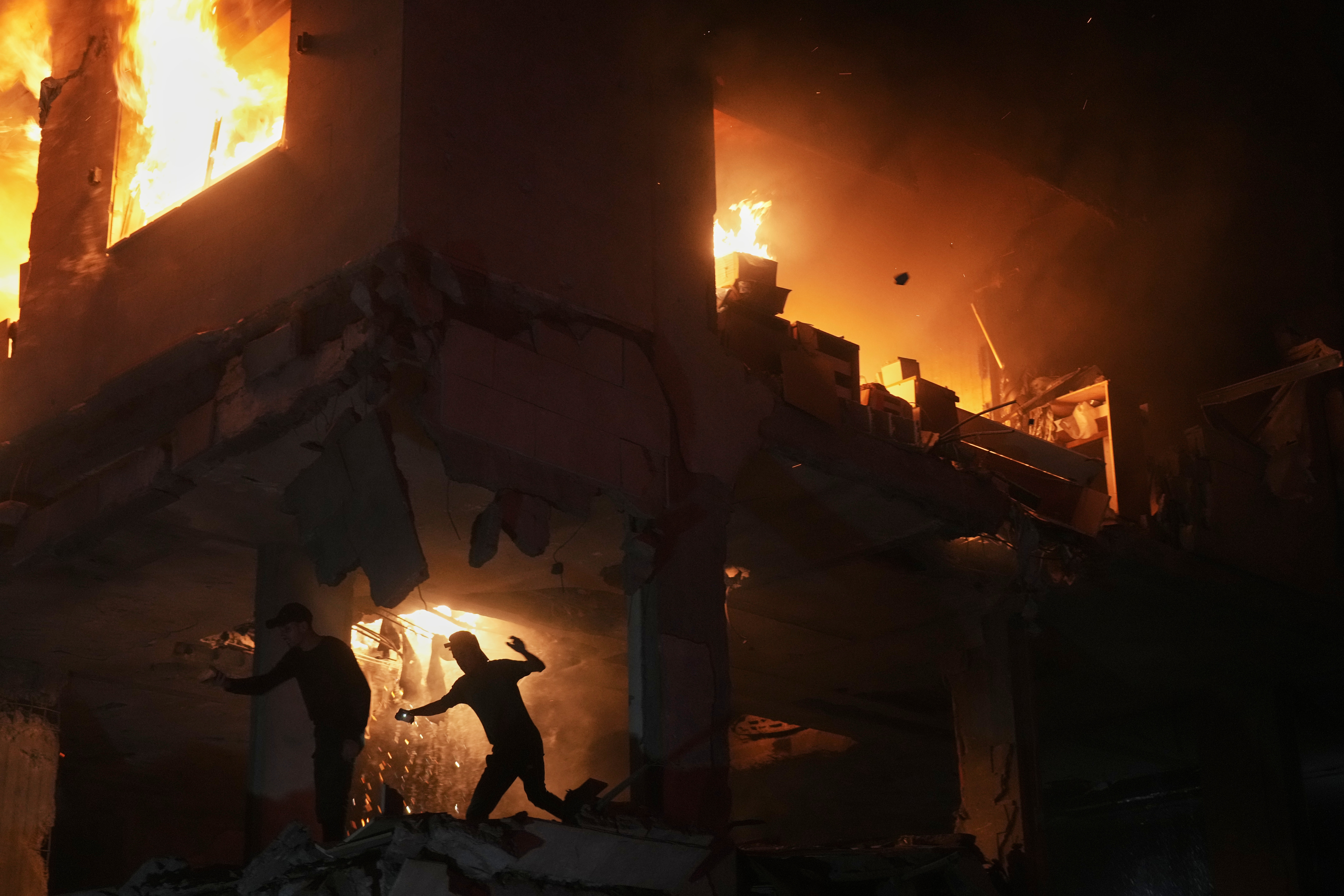 Palestinians react to a fire following an Israeli strike on a residential building in the Rimal neighborhood of Gaza City, Friday, May 15, 2026