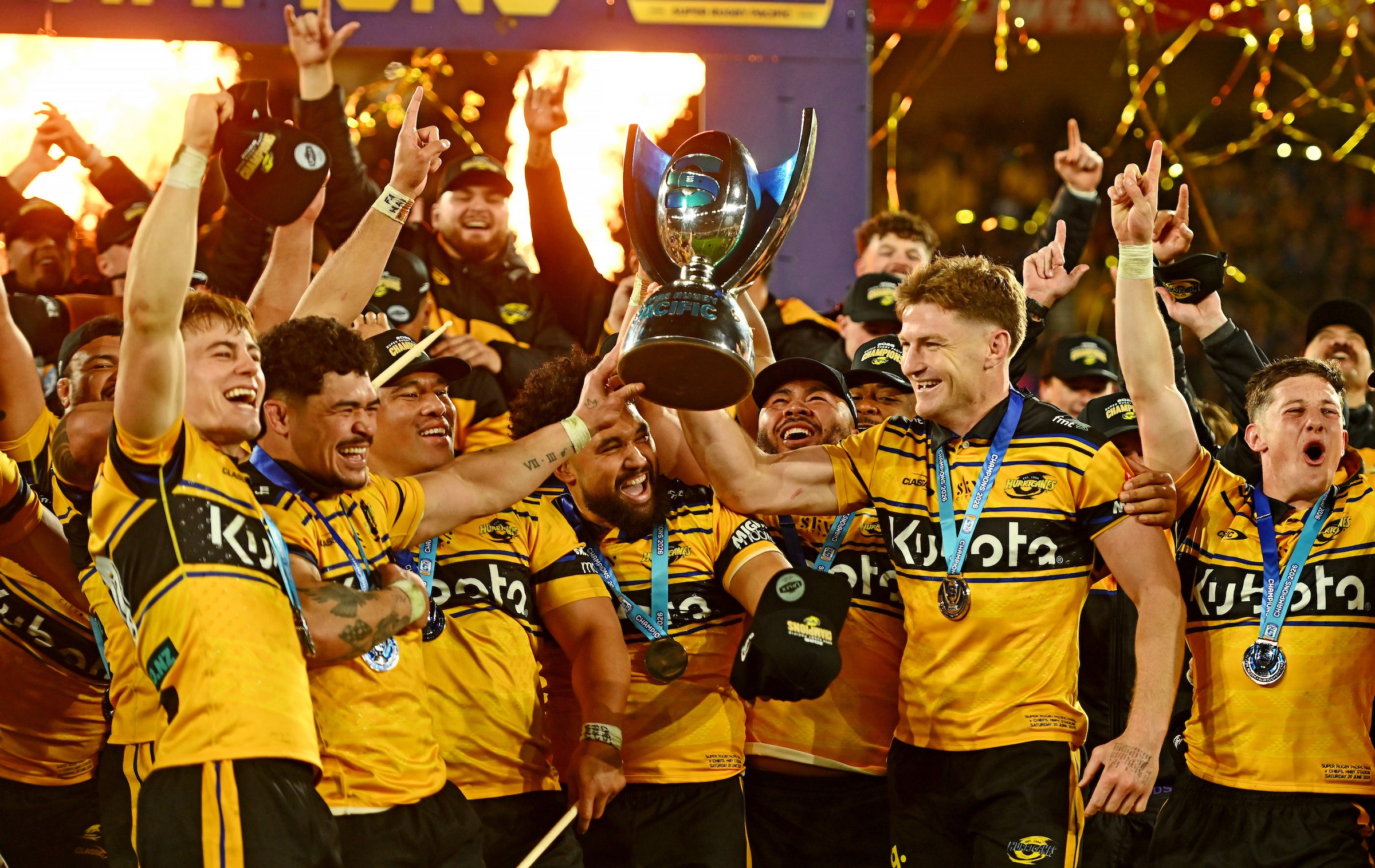 Hurricanes co-captains Du'Plessis Kirifi, left, and Jordie Barrett hoist the Super Rugby Pacific trophy to start the celebrations.