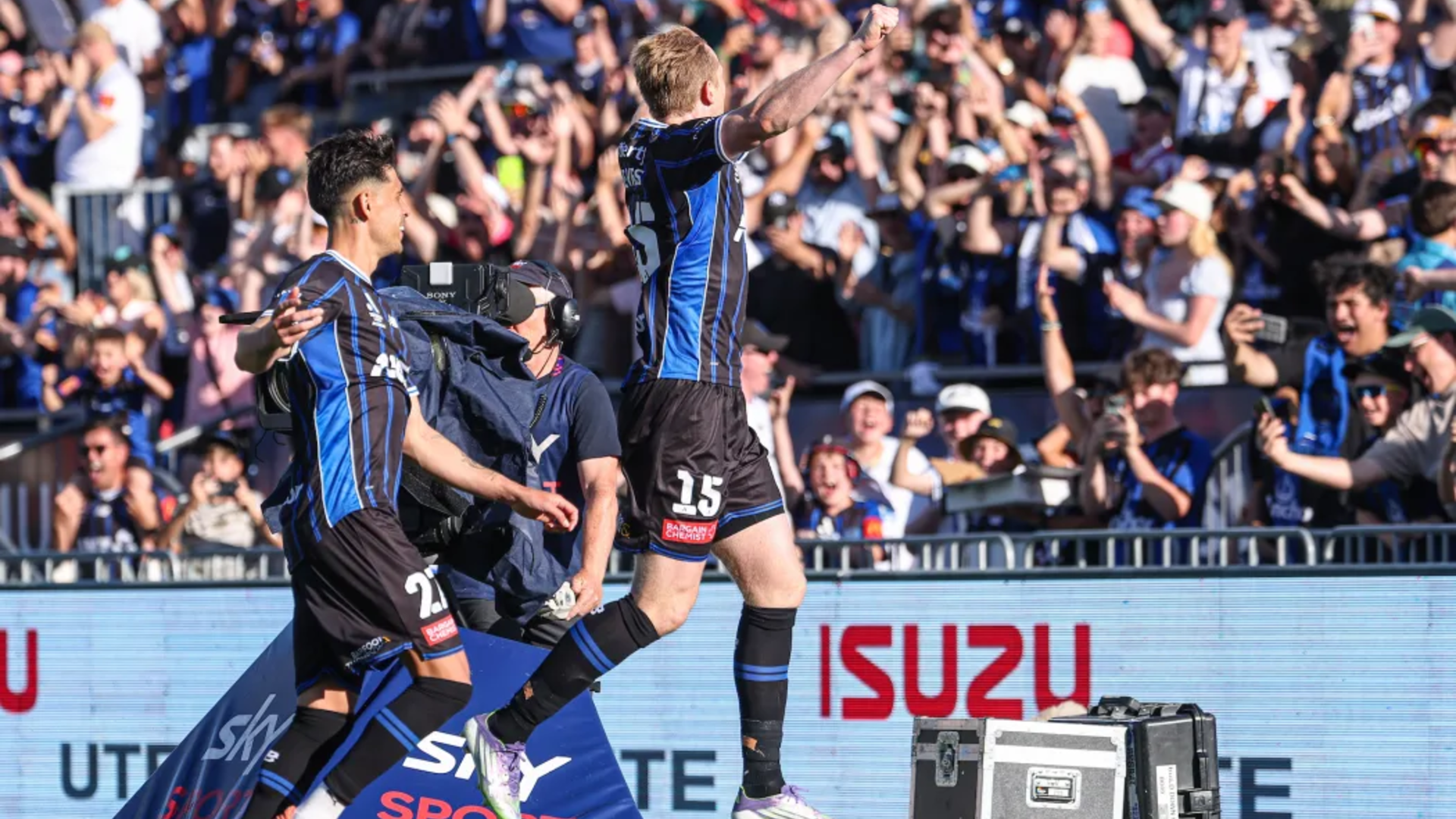 Auckland FC captain Francis de Vries celebrates a goal with fans. 