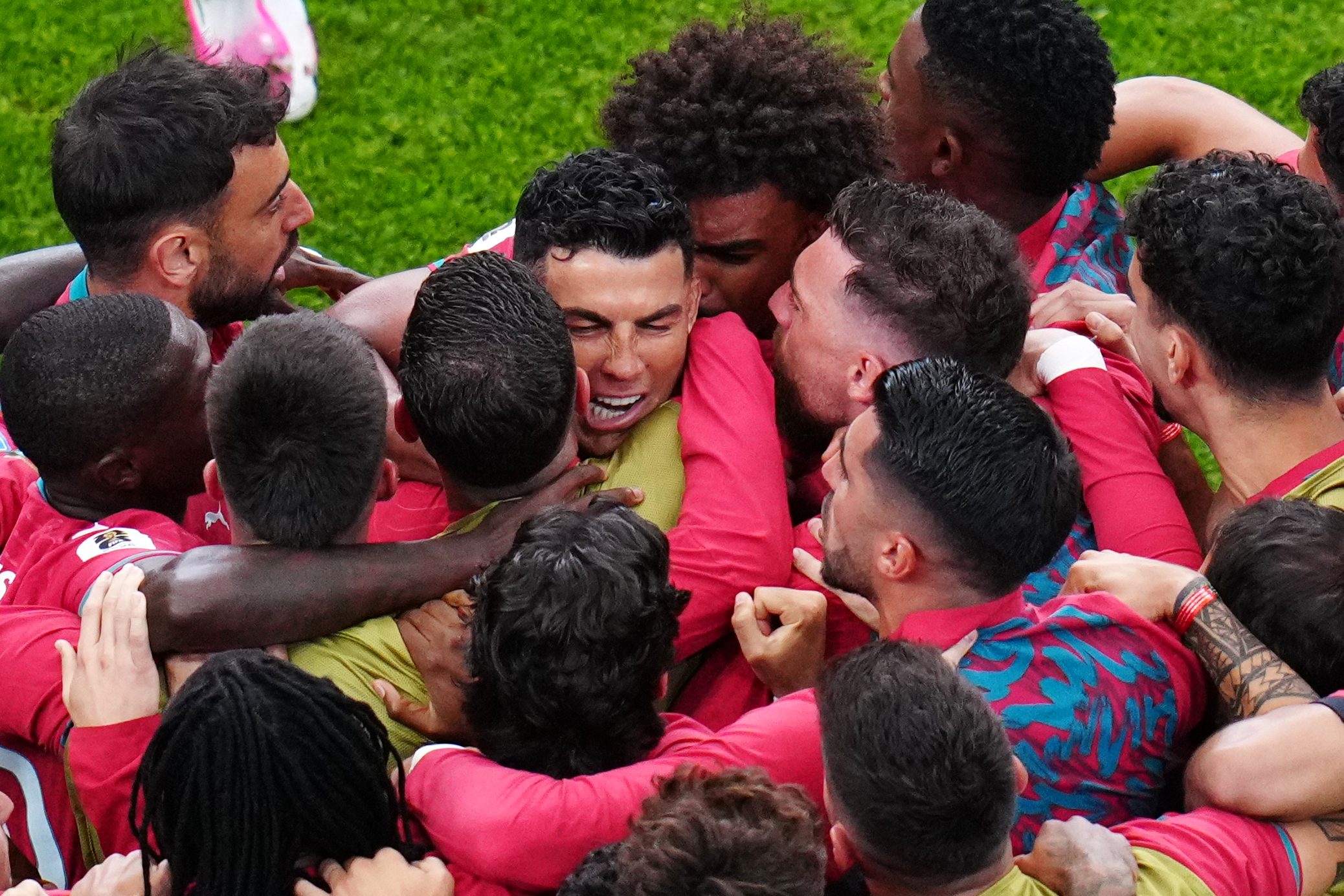 Portugal's Cristiano Ronaldo, centre, celebrates with teammates after scoring the opening goal during the World Cup Group K match between Portugal and Uzbekistan in Houston. 