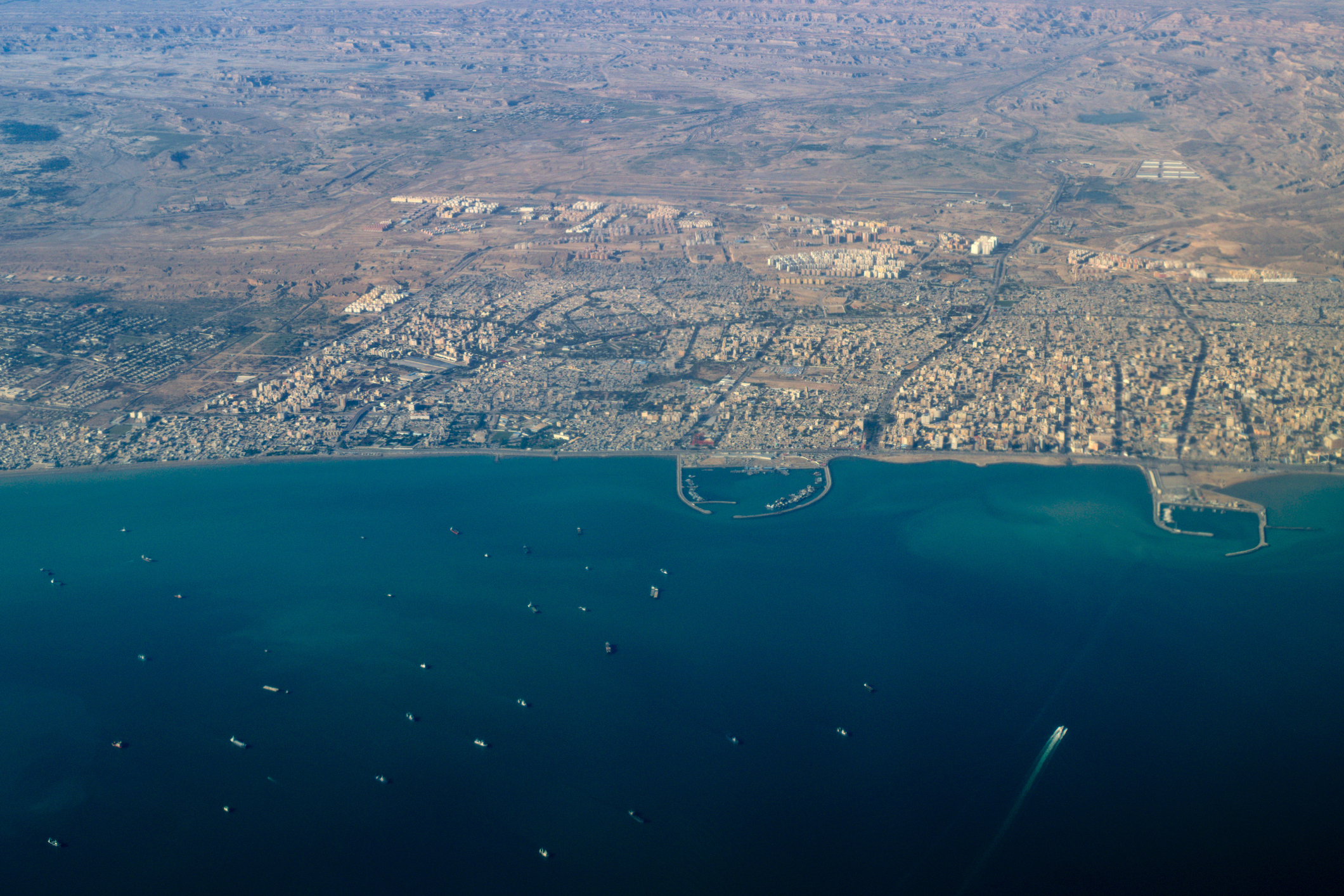 Aerial view of Bandar Abbas major Iranian Persian Gulf port city with several harbors and ship traffic, Strait of Hormuz, Iran.
