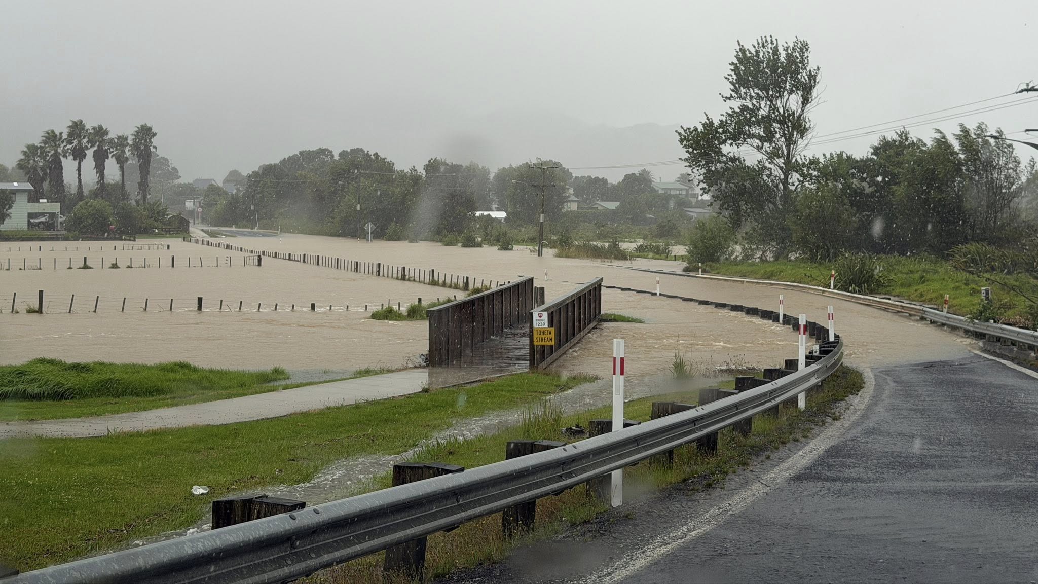 Flooding at the bridge at Wharekaho or Simpsons Beach closing the road towards Matarangi.