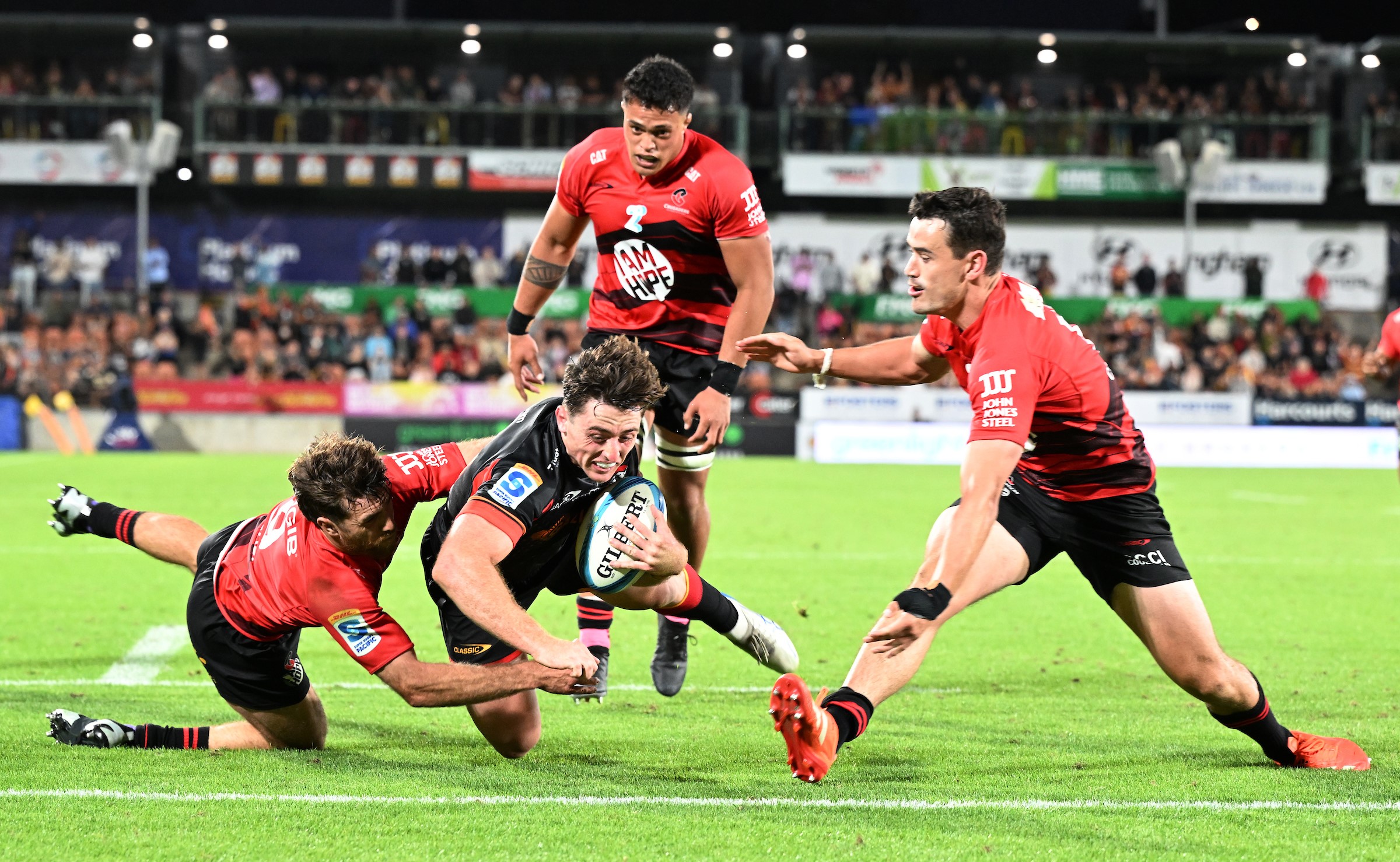 Josh Jacomb dives over the Chiefs against the Crusaders in Hamilton.